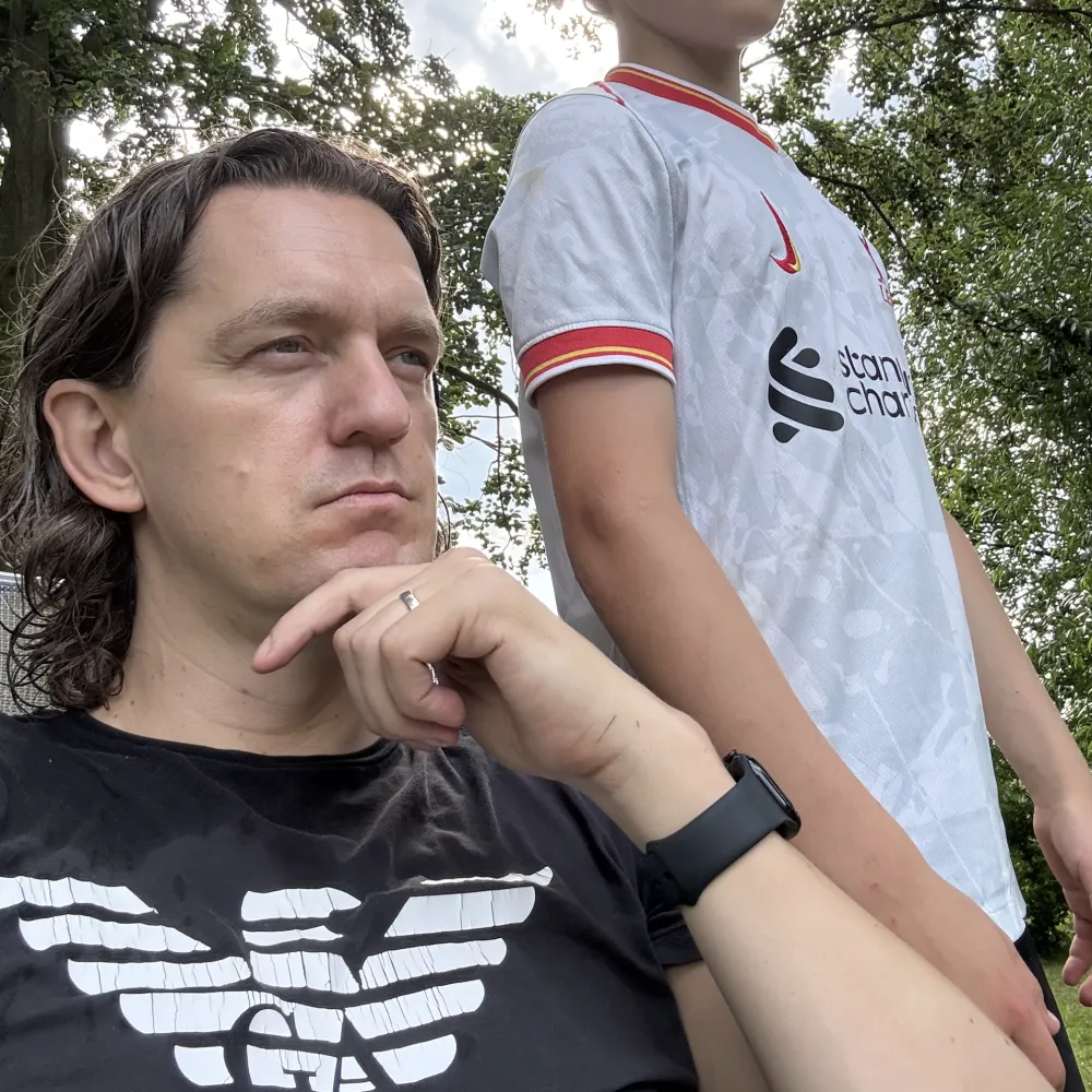 Coen Stevens gazing into the distance with one of his kids beside him